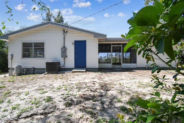 11409 Spring Hill Dr, Spring Hill, FL 34609 - back of house with central air condition unit and a sunroom