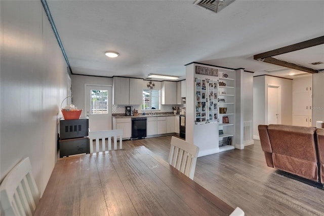 dining room featuring wood finished floors and baseboards
