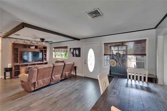 living area with wood finished floors, beam ceiling, baseboards, and a ceiling fan