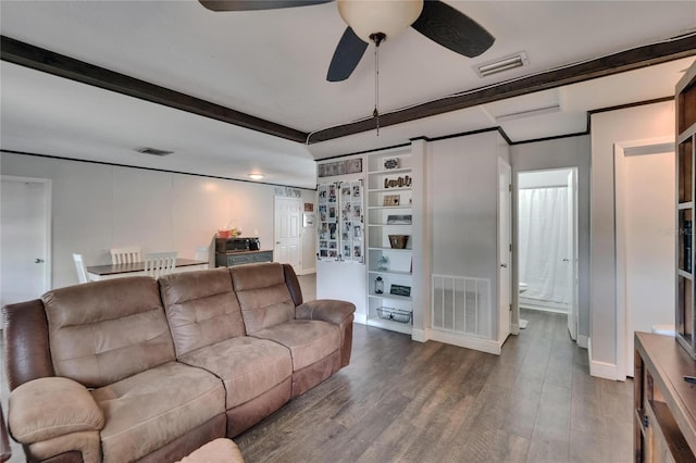 living area featuring a ceiling fan, wood finished floors, beamed ceiling, and baseboards