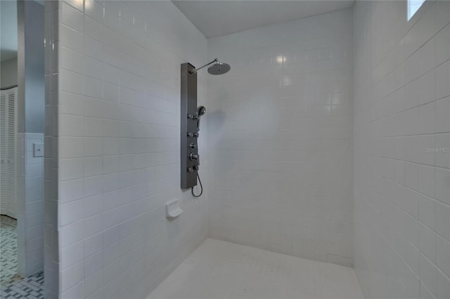 full bath with a tile shower