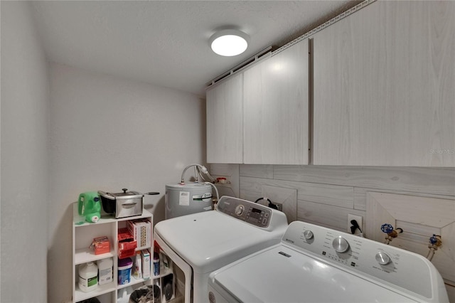 laundry area featuring cabinet space, electric water heater, and separate washer and dryer