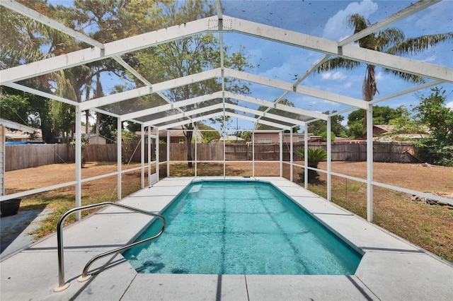 view of pool with a fenced backyard, a lanai, and a patio area