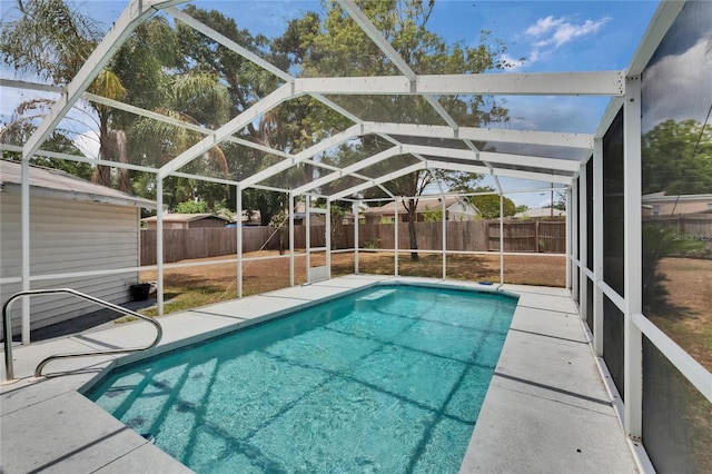 view of swimming pool with a fenced backyard, a lanai, and a patio area