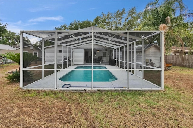 view of pool with a patio, a lanai, and a ceiling fan