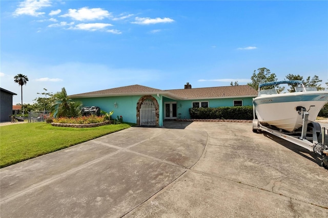 6530 Manila Palm Way, Apollo Beach, FL 33572 - single story home with a chimney and french doors