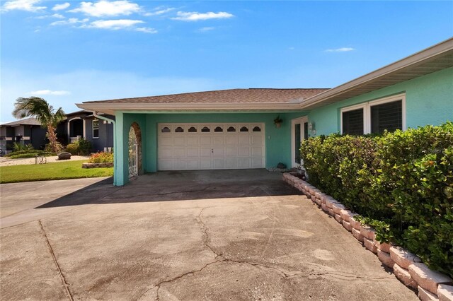 6530 Manila Palm Way, Apollo Beach, FL 33572 - view of front of home featuring concrete driveway, a garage, and stucco siding