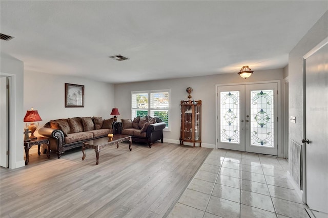 6530 Manila Palm Way, Apollo Beach, FL 33572 - living area with french doors, baseboards, and light wood-style floors