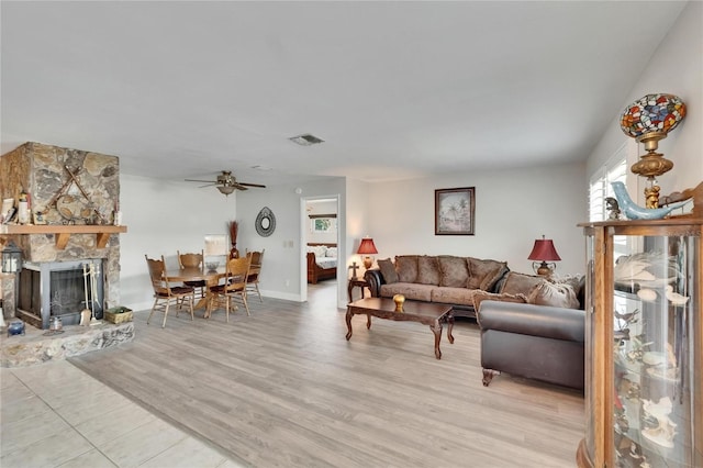 6530 Manila Palm Way, Apollo Beach, FL 33572 - living room with ceiling fan, light wood-style floors, a fireplace, and baseboards
