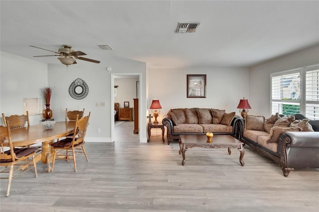 6530 Manila Palm Way, Apollo Beach, FL 33572 - living room featuring wood finished floors, a ceiling fan, and baseboards