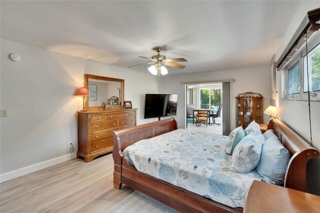 6530 Manila Palm Way, Apollo Beach, FL 33572 - bedroom featuring light wood-style flooring, baseboards, a ceiling fan, and access to outside
