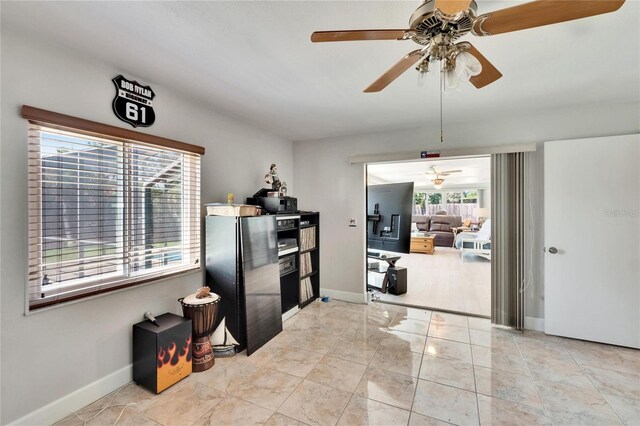 6530 Manila Palm Way, Apollo Beach, FL 33572 - empty room with ceiling fan, plenty of natural light, baseboards, and light marble finish flooring