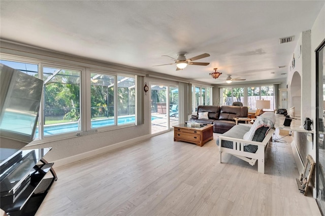6530 Manila Palm Way, Apollo Beach, FL 33572 - living room featuring light wood-style flooring, a ceiling fan, baseboards, and arched walkways
