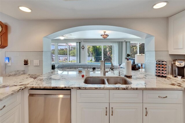 6530 Manila Palm Way, Apollo Beach, FL 33572 - kitchen with dishwasher, arched walkways, a sink, and tasteful backsplash