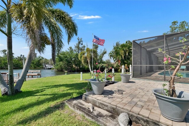 6530 Manila Palm Way, Apollo Beach, FL 33572 - view of grassy yard with a water view, an outdoor pool, a patio, and a lanai