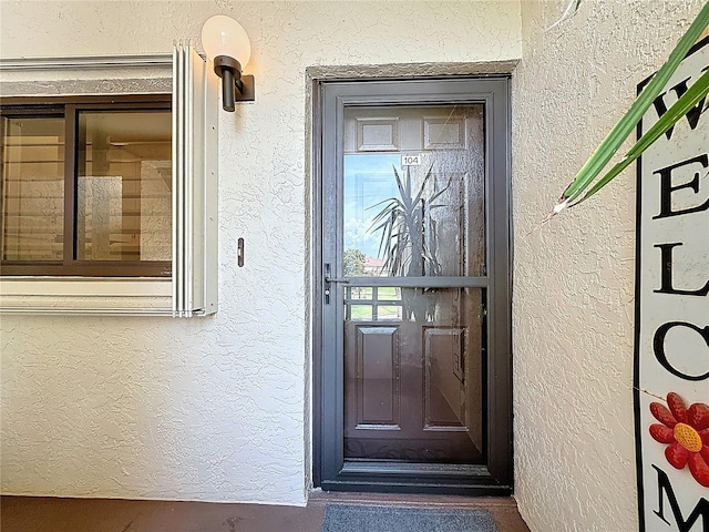 120 1st St E Unit 104, Saint Petersburg, FL 33715 - view of exterior entry featuring stucco siding