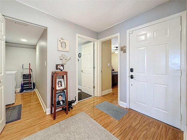 120 1st St E Unit 104, Saint Petersburg, FL 33715 - foyer with light wood-type flooring and washing machine and dryer
