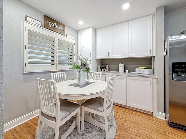 120 1st St E Unit 104, Saint Petersburg, FL 33715 - dining room with light wood-type flooring, recessed lighting, and a textured wall