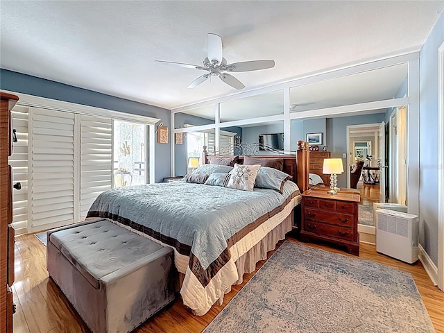 120 1st St E Unit 104, Saint Petersburg, FL 33715 - bedroom featuring light wood-style floors, access to outside, a ceiling fan, and refrigerator