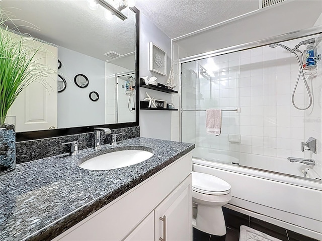 120 1st St E Unit 104, Saint Petersburg, FL 33715 - full bathroom featuring vanity, combined bath / shower with glass door, and a textured ceiling
