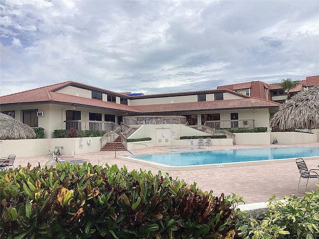 120 1st St E Unit 104, Saint Petersburg, FL 33715 - community pool featuring a jacuzzi, stairs, and a patio