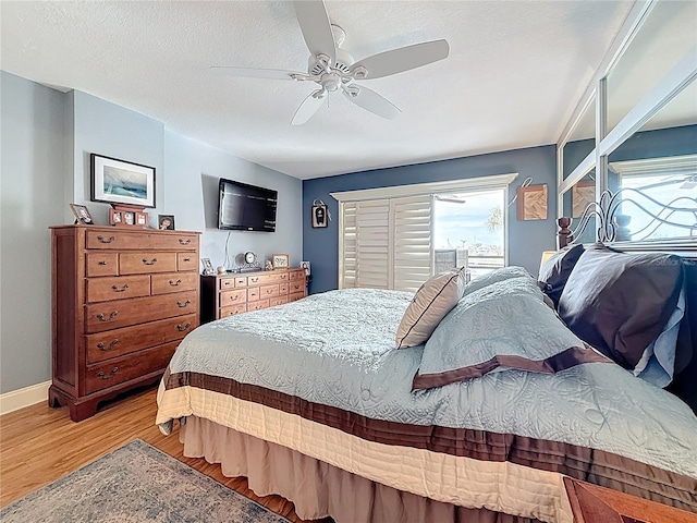 120 1st St E Unit 104, Saint Petersburg, FL 33715 - bedroom featuring light wood finished floors and ceiling fan