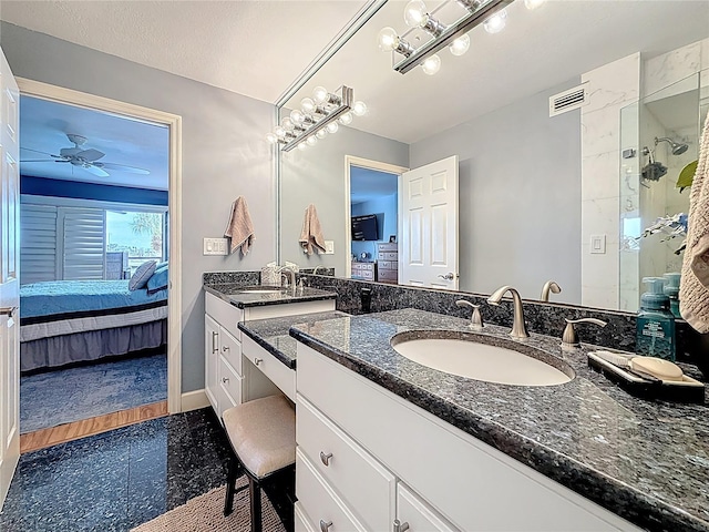 120 1st St E Unit 104, Saint Petersburg, FL 33715 - full bath featuring ensuite bathroom, two vanities, granite tiled floors, a shower stall, and ceiling fan