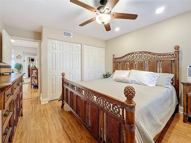 120 1st St E Unit 104, Saint Petersburg, FL 33715 - bedroom featuring two closets, light wood-style flooring, ceiling fan, and recessed lighting