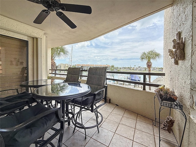 120 1st St E Unit 104, Saint Petersburg, FL 33715 - balcony with ceiling fan, outdoor dining area, and a water view