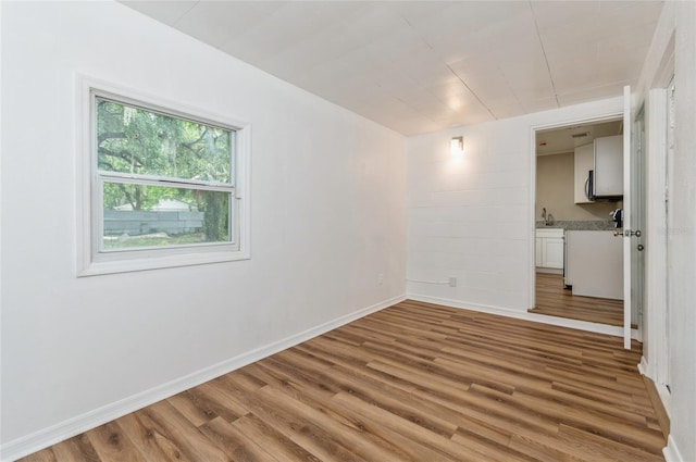 1727 Bonita Ave, Orlando, FL 32805 - empty room with wood finished floors and baseboards