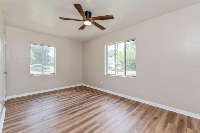 1727 Bonita Ave, Orlando, FL 32805 - empty room with wood finished floors, a ceiling fan, and baseboards