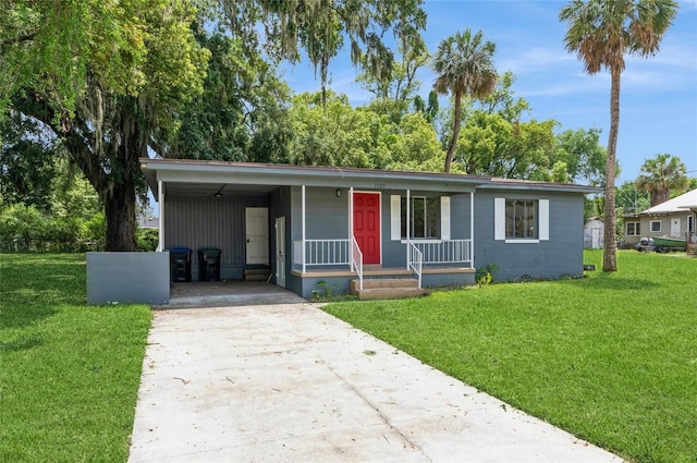 1727 Bonita Ave, Orlando, FL 32805 - view of front facade with concrete driveway, covered porch, a front lawn, and an attached carport
