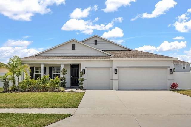 921 Fieldstone Way, Haines City, FL 33844 - view of front of home featuring a garage, a shingled roof, concrete driveway, a front yard, and stucco siding