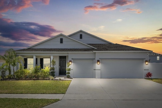921 Fieldstone Way, Haines City, FL 33844 - view of front of house with a garage, driveway, roof with shingles, and a lawn
