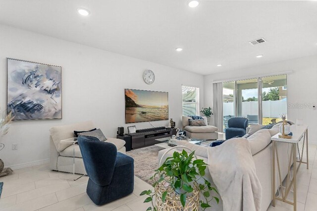 921 Fieldstone Way, Haines City, FL 33844 - living room with recessed lighting, baseboards, and light tile patterned floors