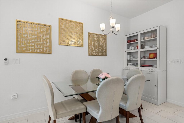 921 Fieldstone Way, Haines City, FL 33844 - dining space with a chandelier, baseboards, and light tile patterned floors