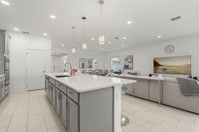 921 Fieldstone Way, Haines City, FL 33844 - kitchen with gray cabinets, a sink, open floor plan, light countertops, and recessed lighting