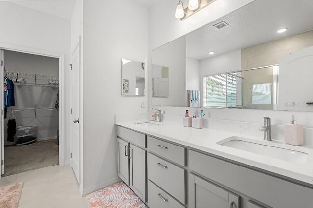 921 Fieldstone Way, Haines City, FL 33844 - full bath featuring a shower stall, double vanity, a spacious closet, and recessed lighting