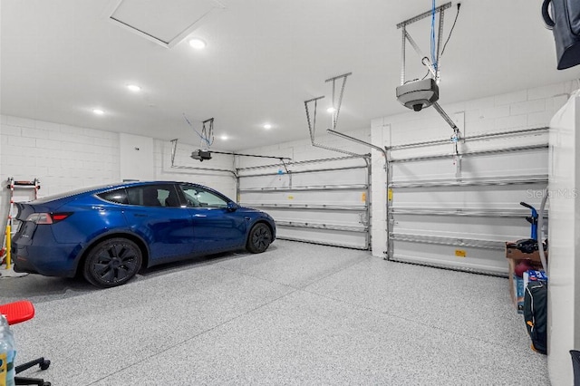 921 Fieldstone Way, Haines City, FL 33844 - garage with a garage door opener, concrete block wall, and recessed lighting