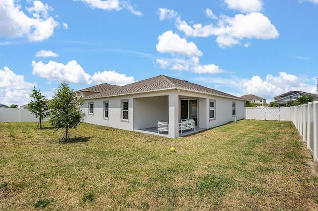 921 Fieldstone Way, Haines City, FL 33844 - rear view of property with a patio area, stucco siding, and a tile roof