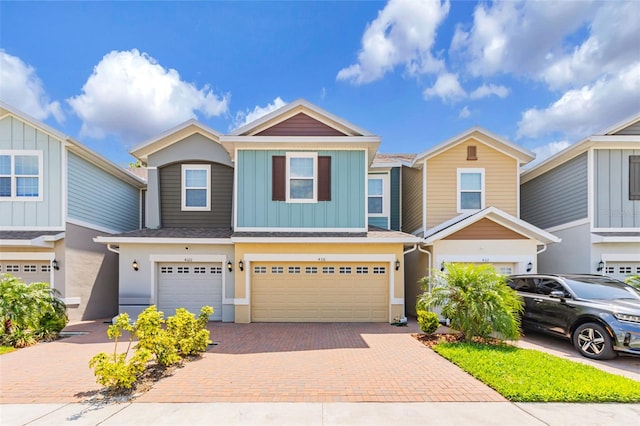 4316 Sailplane Ct, Wesley Chapel, FL 33545 - townhome / multi-family property with a garage, decorative driveway, stucco siding, and board and batten siding