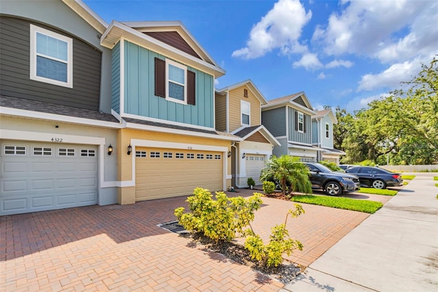 4316 Sailplane Ct, Wesley Chapel, FL 33545 - view of property featuring board and batten siding, driveway, and an attached garage