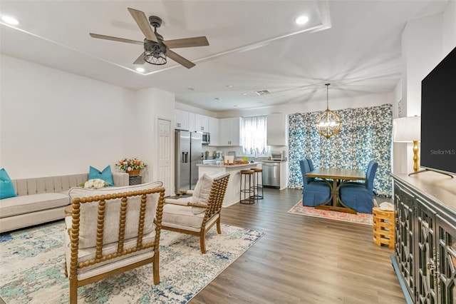 4316 Sailplane Ct, Wesley Chapel, FL 33545 - living room with recessed lighting, a ceiling fan, wood finished floors, and a chandelier
