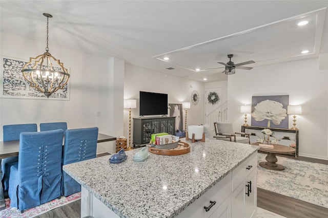 4316 Sailplane Ct, Wesley Chapel, FL 33545 - kitchen featuring open floor plan, dark wood finished floors, white cabinets, light stone countertops, and recessed lighting