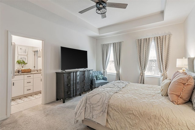4316 Sailplane Ct, Wesley Chapel, FL 33545 - bedroom featuring light colored carpet, a tray ceiling, connected bathroom, and a ceiling fan