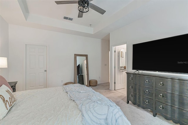 4316 Sailplane Ct, Wesley Chapel, FL 33545 - bedroom with a tray ceiling, light carpet, connected bathroom, and a ceiling fan