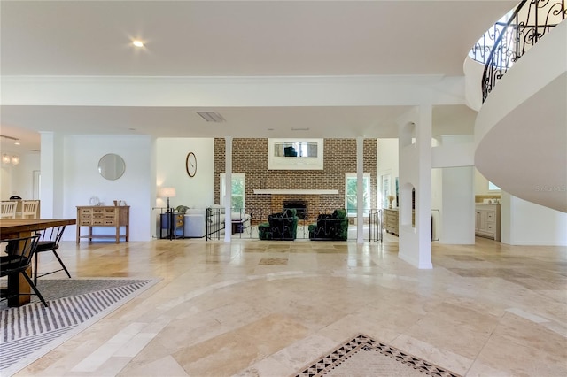 1089 Virginia St, Dunedin, FL 34698 - living room featuring a brick fireplace, crown molding, and stairs