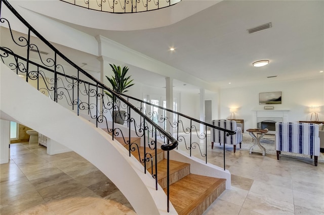 1089 Virginia St, Dunedin, FL 34698 - stairway featuring a fireplace and ornamental molding