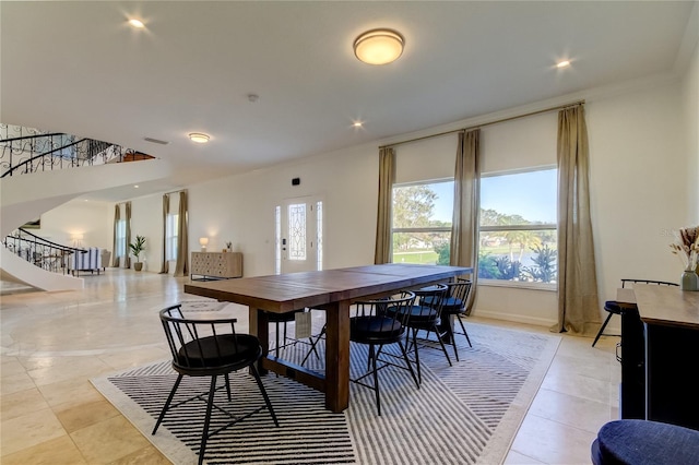 1089 Virginia St, Dunedin, FL 34698 - dining room with stairs, healthy amount of natural light, crown molding, light tile patterned floors, and recessed lighting