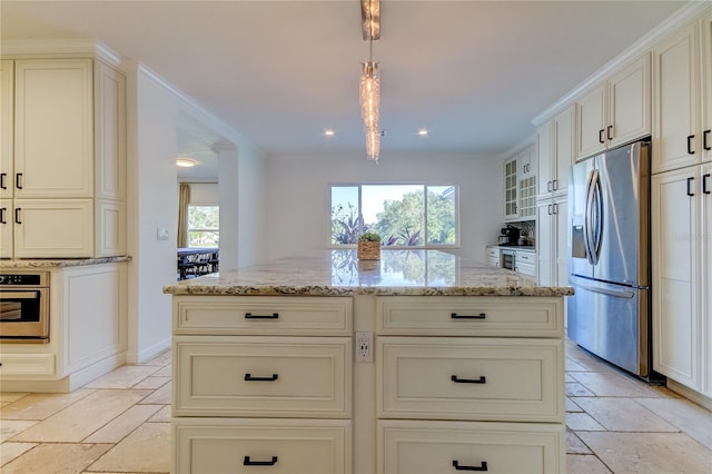 1089 Virginia St, Dunedin, FL 34698 - kitchen featuring appliances with stainless steel finishes, stone tile flooring, light stone countertops, cream cabinets, and recessed lighting